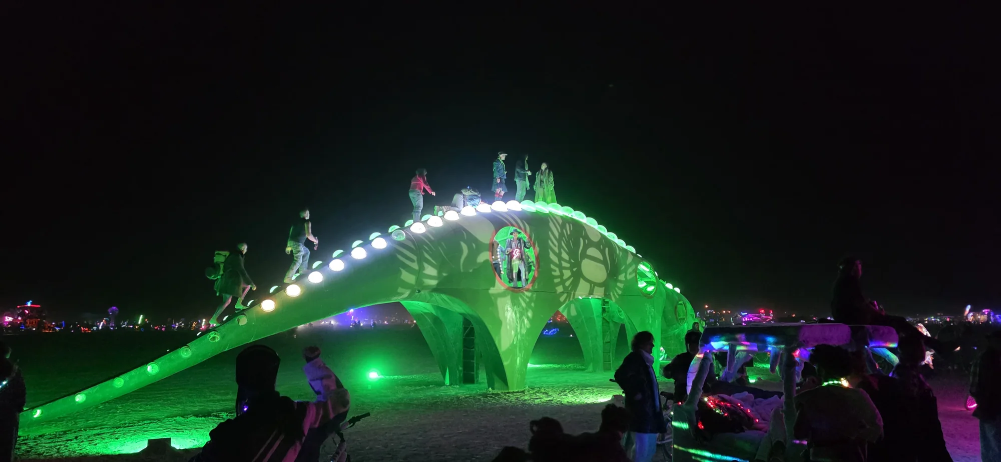 Illuminated art glowing across the playa